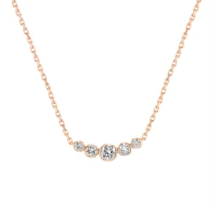 Aélis necklace in 18K gold with a central round diamond and four smaller diamonds set in a graceful curve on a fine chain.