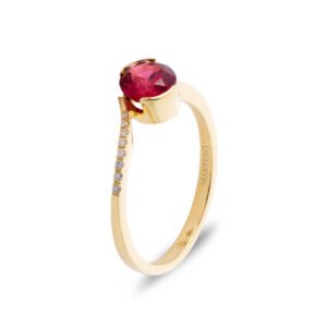 Yellow gold ring with curved band set with an oval tourmaline and eight small round diamonds in graduated sizes
