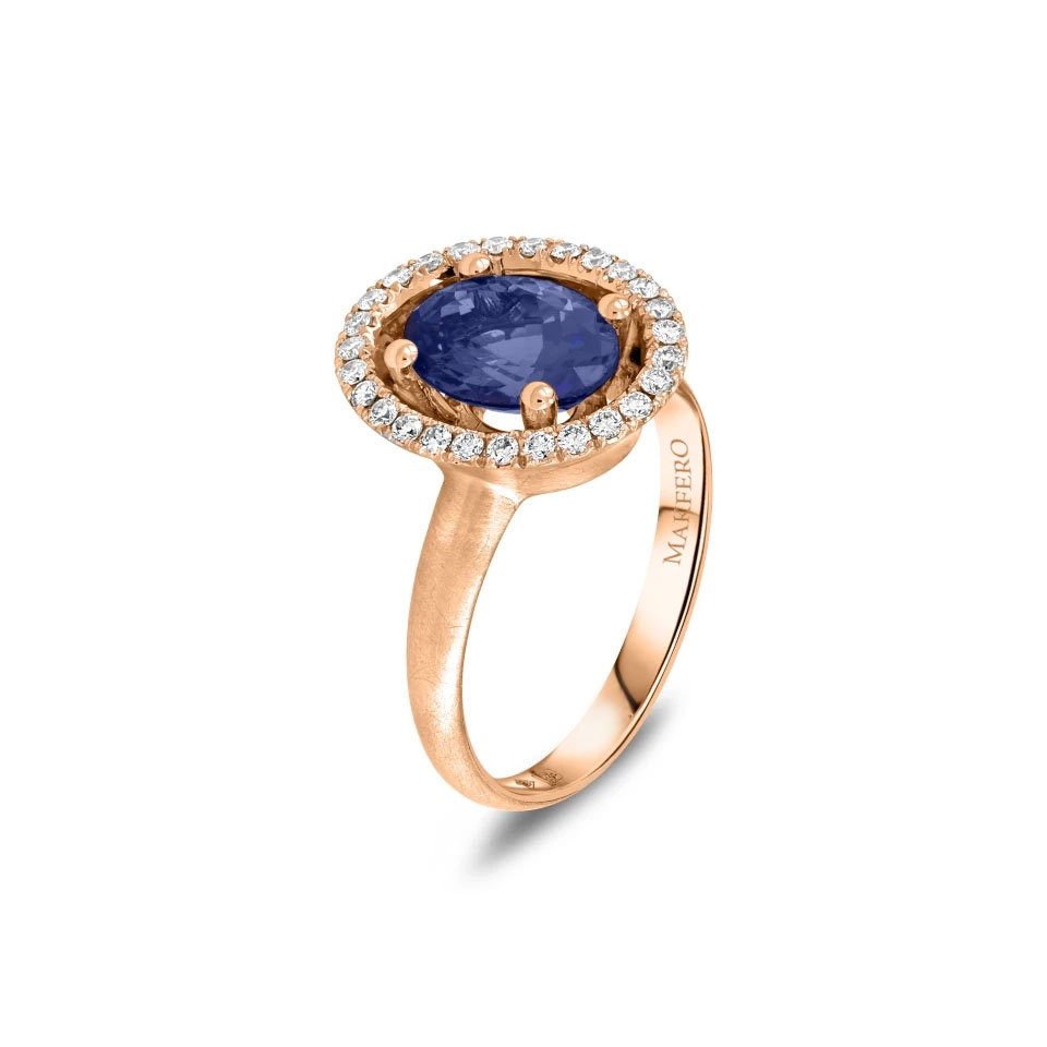 Rose gold ring with an oval tanzanite, 8.9 × 6.8 mm, surrounded by 27 small round diamonds in a halo setting