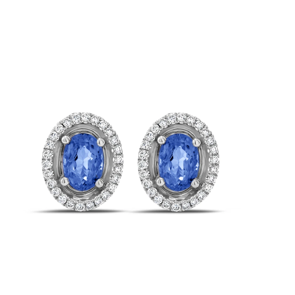 Pair of Aurore earrings in 18K white gold with oval tanzanites and a diamond halo