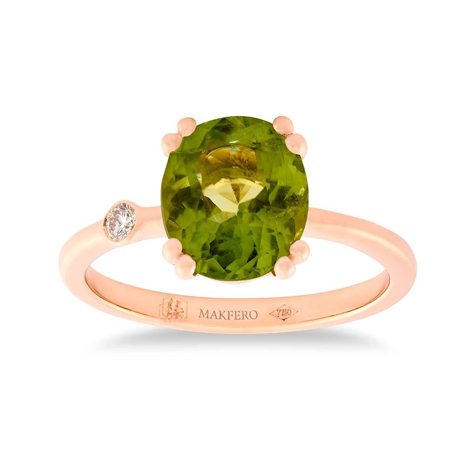 Rose gold ring with oval peridot and a single round diamond set on the band