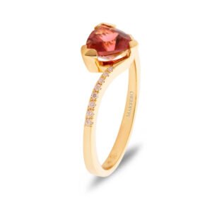 Yellow gold ring with curved band set with a trillion-cut pink tourmaline and sixteen small round diamonds in graduated sizes