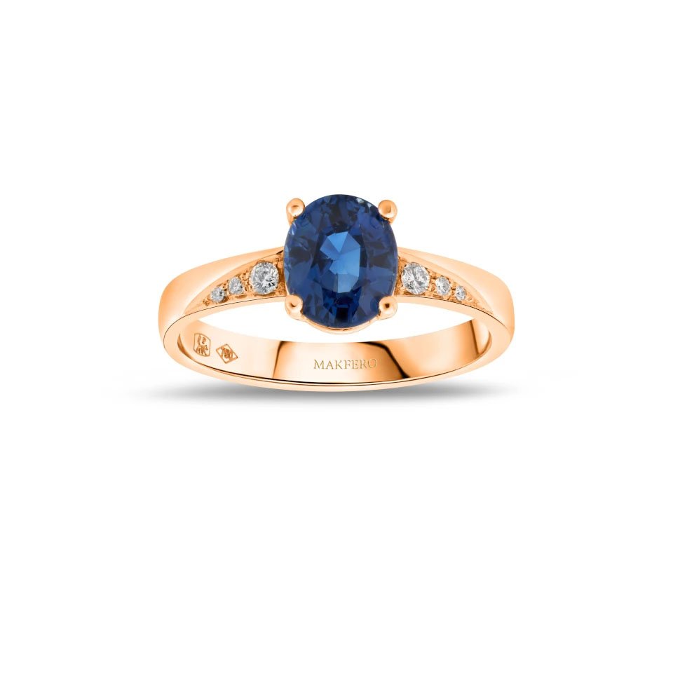 Rose gold ring with an oval sapphire, 7.25 × 6 mm, and six small round diamonds on the band