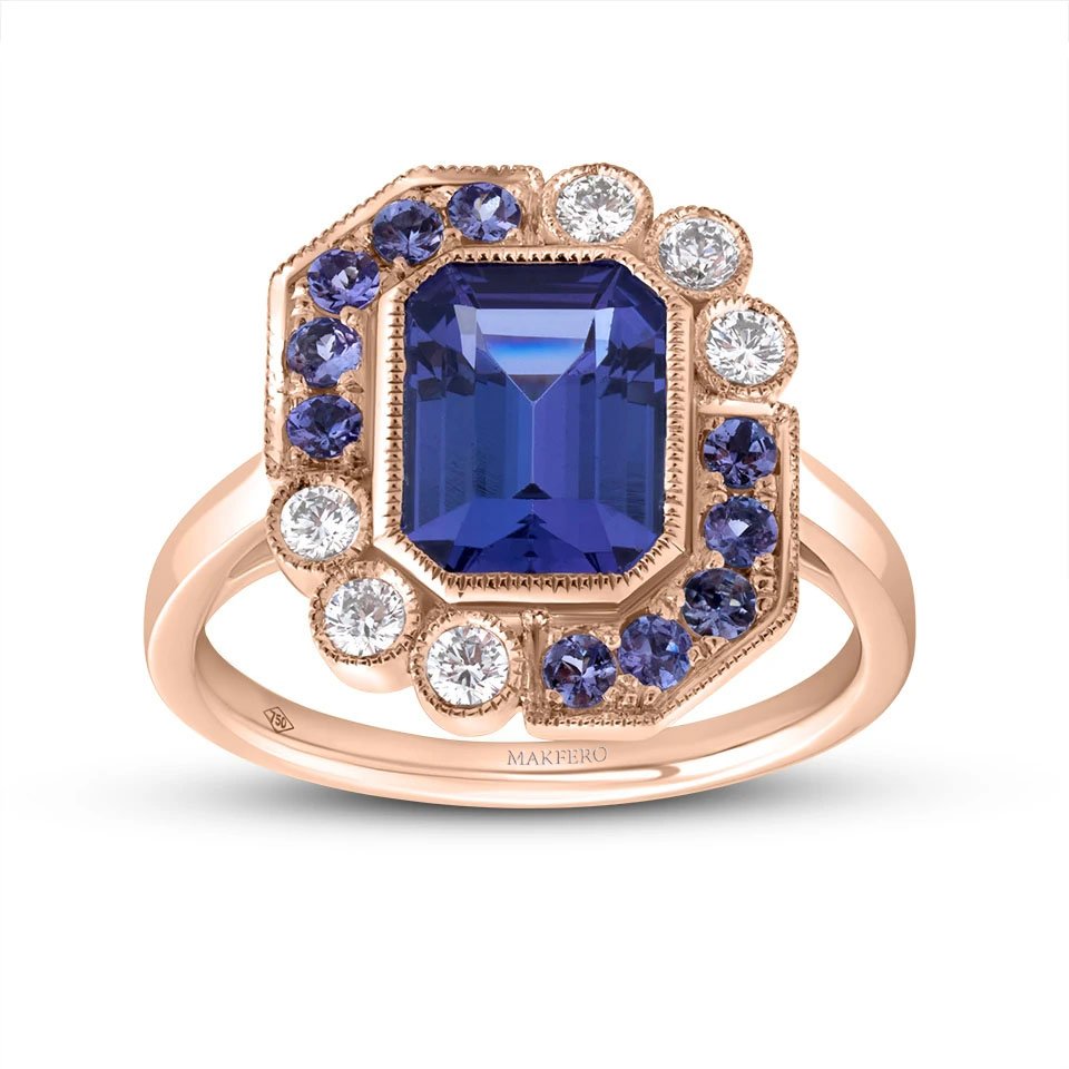 Rose gold ring with a central emerald-cut tanzanite, 7 × 9 mm, surrounded by six round diamonds and ten round tanzanites in a geometric halo design