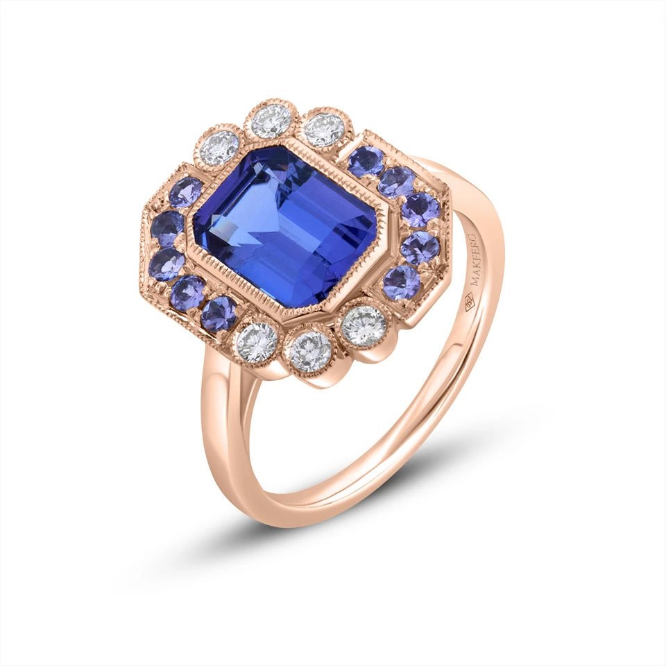 Rose gold ring with a central emerald-cut tanzanite, 7 × 9 mm, surrounded by six round diamonds and ten round tanzanites in a geometric halo design