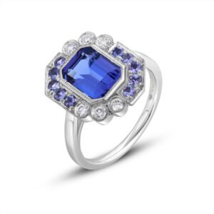 White gold ring with a central emerald-cut tanzanite, 7 × 9 mm, surrounded by six round diamonds and ten round tanzanites in a geometric halo design