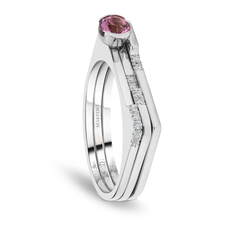 White gold ring combining tourmaline center stone with eleven small round diamonds set in a geometric modern band