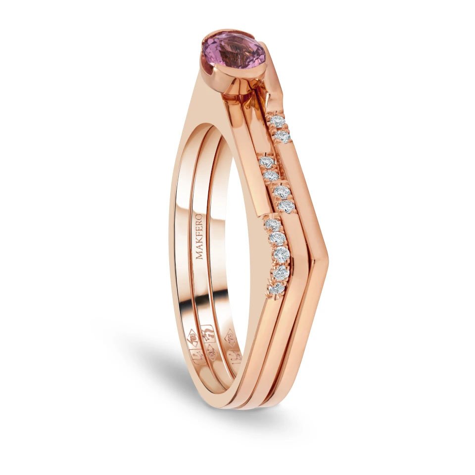 Rose gold ring combining tourmaline center stone with eleven small round diamonds set in a geometric modern band